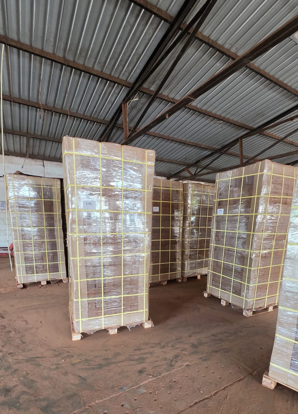 Palletised coco peat blocks strapped and stretch-wrapped in the despatch shed